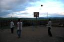 The drivers and family members play basketball at sunset