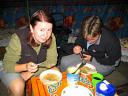 Megan and Vanessa eat noodle soup in the ger