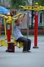 Man on the public exercise machines